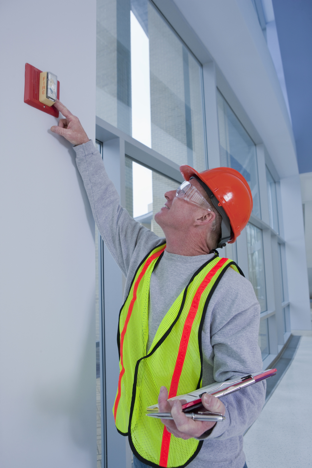 man testing fire alarm